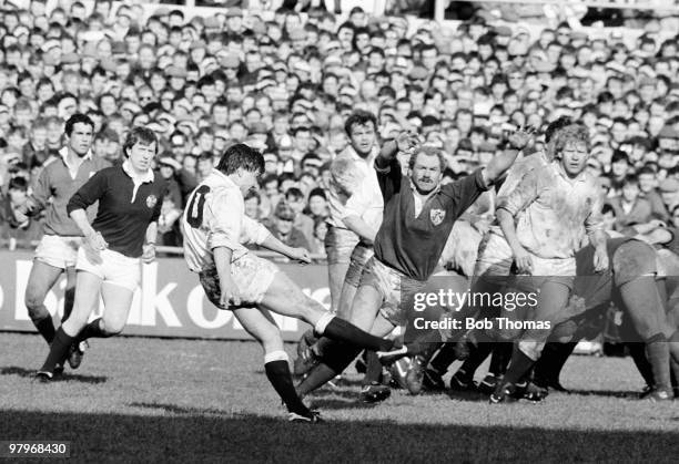 Rob Andrew of England kicks the ball with Nigel Carr of Ireland trying to block during the Ireland v England Rugby Union International match played...