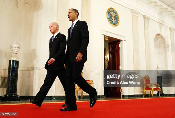 President Barack Obama and Vice President Joseph Biden walk toward the East Room for the signing ceremony of the Affordable Health Care for America...