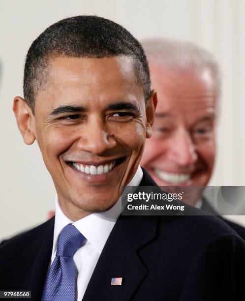 President Barack Obama and Vice President Joseph Biden smile during the signing ceremony of the Affordable Health Care for America Act in the East...