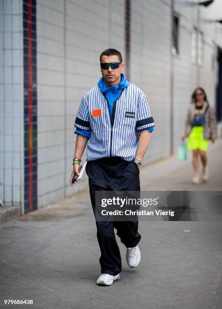 Alex Badia wearing blue white striped MSGM button shirt seen outside Acne on day two of Paris Fashion Week Menswear SS19 on June 20, 2018 in Paris,...