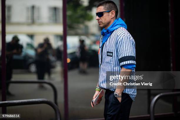 Alex Badia wearing blue white striped MSGM button shirt seen outside Acne on day two of Paris Fashion Week Menswear SS19 on June 20, 2018 in Paris,...