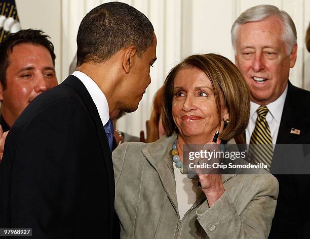 Speaker of the House Nancy Pelosi holds one of the pens that President Barack Obama used to sign the Affordable Health Care for America Act during a...