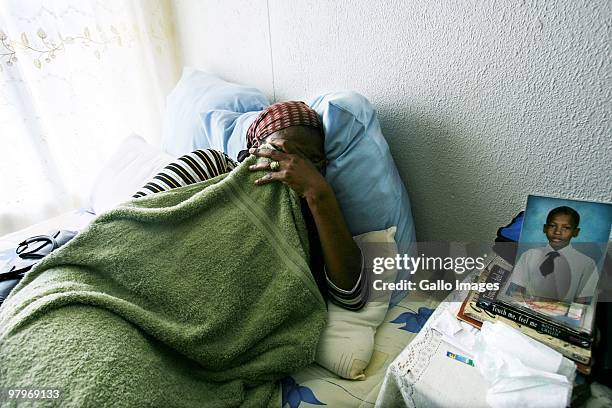 Mameetse Masemola mother of deceased Phomelelo grieves with a picture of her son by her bedside at her home on March 9, 2010 in Soweto, Johannesburg,...