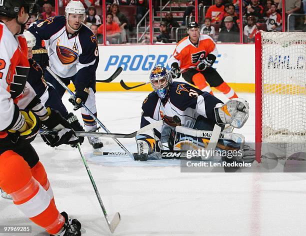 Chris Pronger takes a slapshot on goal with teammate Jeff Carter of the Philadelphia Flyers against Ron Hainsey and Ondrej Pavelec of the Atlanta...