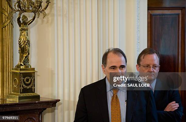 White House advisor David Axelrod and Press Secretary Robert Gibbs stand prior to US President Barack Obama signing the healthcare insurance reform...