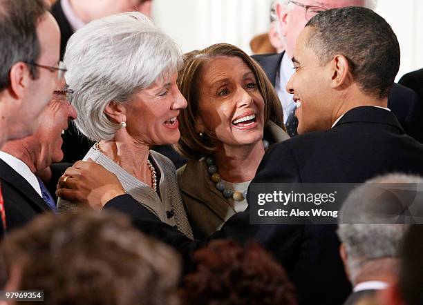 President Barack Obama talks to Speaker of the House Rep. Nancy Pelosi , and Health and Human Services Secretary Kathleen Sebelius after he signed...