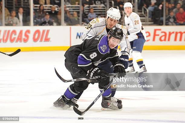Drew Doughty of the Los Angeles Kings battles for the puck against Jordin Tootoo of the Nashville Predators on March 14, 2010 at Staples Center in...