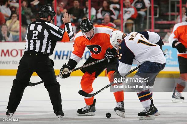 Referee Kerry Fraser drops the puck on a face-off between Jeff Carter of the Philadelphia Flyers and Todd White of the Atlanta Thrashers on March 21,...