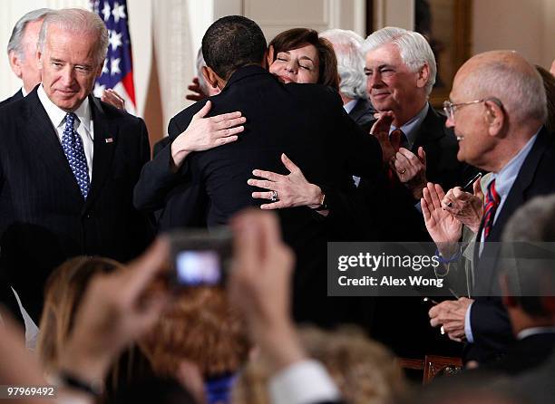 President Barack Obama hugs widow of the late Sen. Edward Kennedy Vicki Kennedy as Vice President Joseph Biden , Sen. Chirstopher Dodd , and Rep....