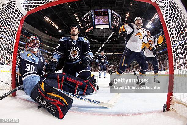 Goaltender Scott Clemmensen of the Florida Panthers unsuccessfully defends the net with the help of teammate Jason Garrison against the Buffalo...