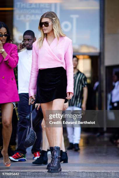 Model Maryna Linchuk wearing pink blouse, black mini skirt, outside Off-White, during Paris Fashion Week - Menswear Spring-Summer 2019, on June 20,...