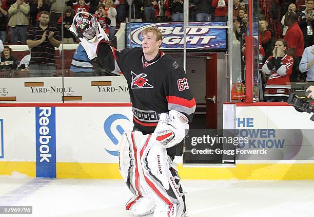 Justin Peters of the Carolina Hurricanes skates out and waves to fans after being named first star of the game after their NHL game against the...