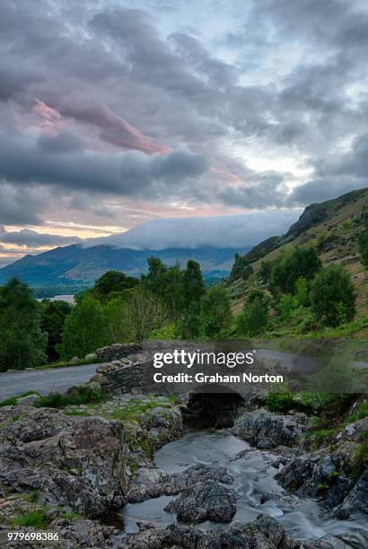 clouds over stone ashness bridge, skiddaw in background, lake district, cumbria, england, uk - cumbrian mountains stock pictures, royalty-free photos & images
