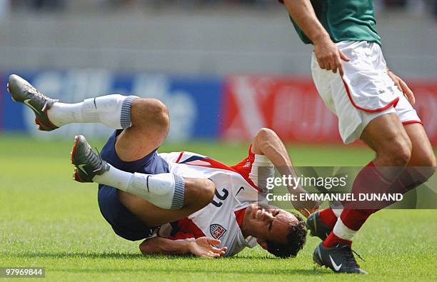 S Landon Donovan falls, 17 June 2002 at the Jeonju World Cup Stadium in Jeonju, during second round playoff action between Mexico and USA in the 2002...