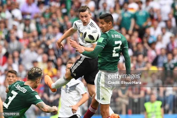Julian Draxler of Germany and Hugo Ayala of Mexico compete for the ball during the 2018 FIFA World Cup Russia group F match between Germany and...