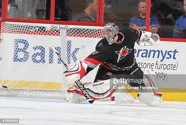 Justin Peters of the Carolina Hurricanes deflects the puck away from the net during a NHL game against the Pittsburgh Penguins on March 11, 2010 at...