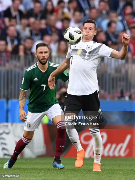 Julian Draxler of Germany and Miguel Layun of Mexico compete for the ball during the 2018 FIFA World Cup Russia group F match between Germany and...