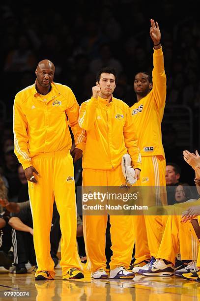 Lamar Odom, Sasha Vujacic and Josh Powell of the Los Angeles Lakers celebrate from the bench after a play against the Denver Nuggets during the game...