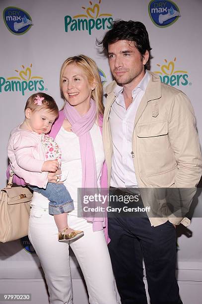 Actors Kelly Rutherford, holding daughter Helena , and Matthew Settle attend the Pampers Dry Max launch party at Helen Mills Theater on March 18,...