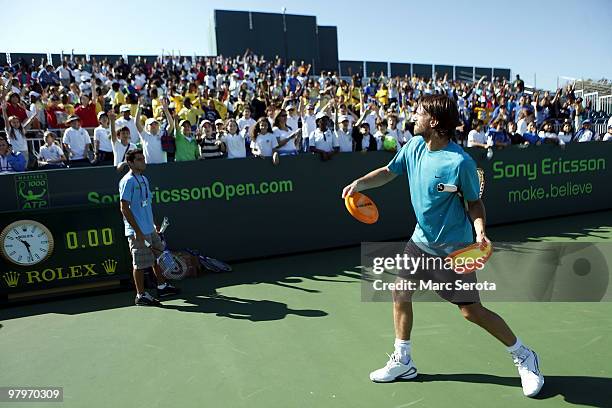 Tennis player Christopher Kas hands out gifts at Kids Day at Crandon Park Tennis Center during the Sony Ericsson Open on March 23, 2010 in Key...