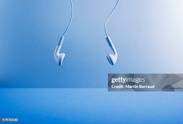 headphones hanging - ohrhörer stock-fotos und bilder