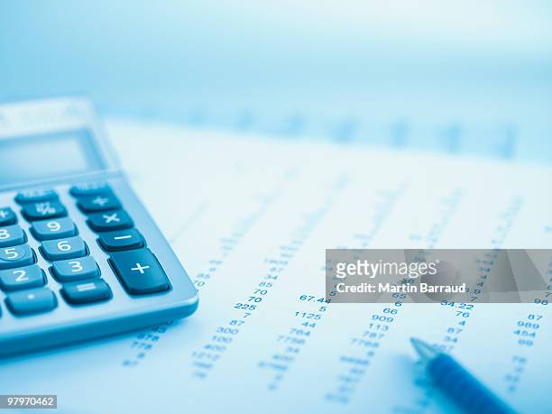 close up of calculator and data - finanza foto e immagini stock