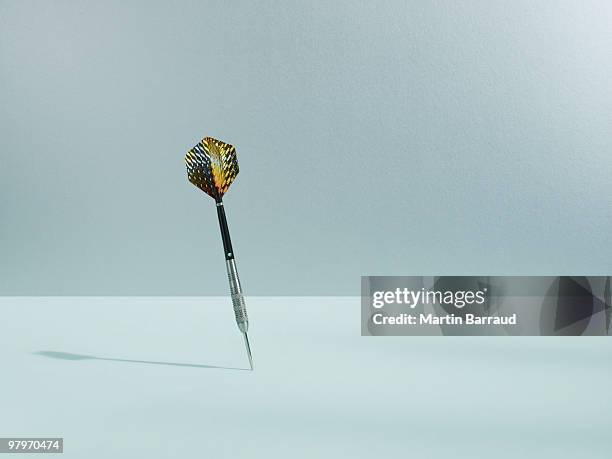 dart sticking in surface - corrects stockfoto's en -beelden