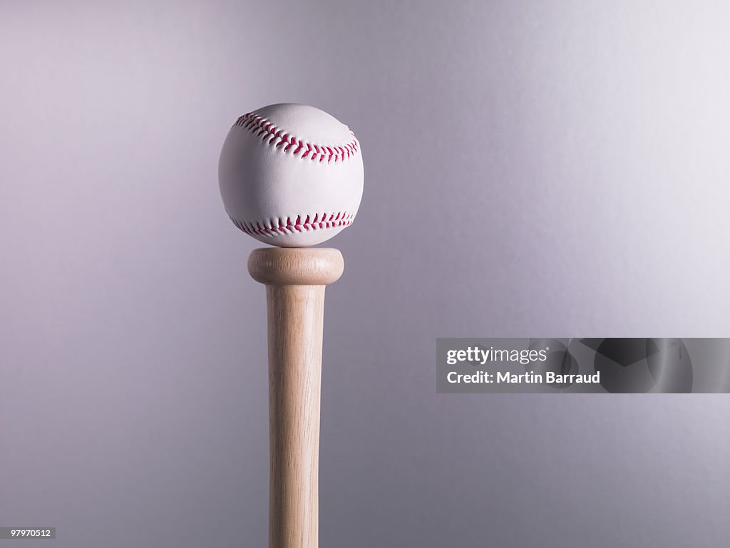 Baseball balancing on bat