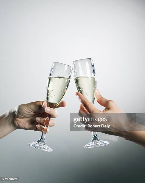 hands holding and toasting champagne flutes - hand glasses stockfoto's en -beelden