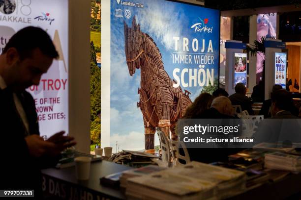 March 2018, Germany, Berlin: A visitor stands next to a stand for the region Troja in the Turkish hall of the International Tourism trade fair ....