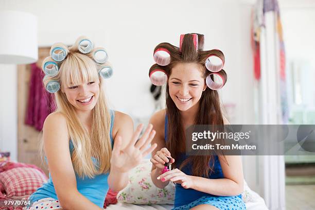 women painting fingernails with curlers in hair - female curler stock pictures, royalty-free photos & images