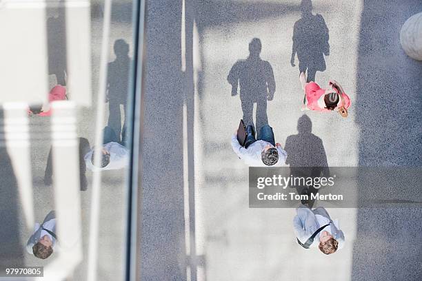 shadows of people walking from directly above - people walking overhead view stock pictures, royalty-free photos & images