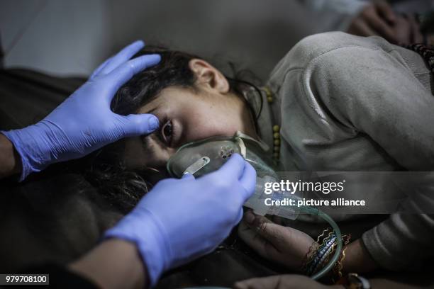 Dpatop - A Syrian child receives first aid after what local sources say was an attack by forces loyal to Syrian President Assad with chlorine gas on...