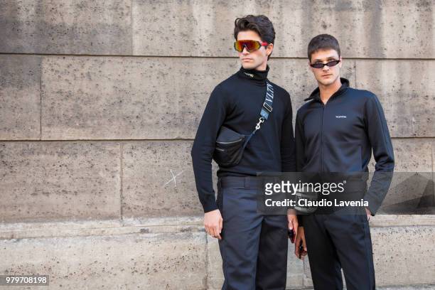 Marc Forne, wearing black pullover, black pants and Valentino belt bag and Guido Milani, wearing black jacket, black pants and Valentino belt bag,...