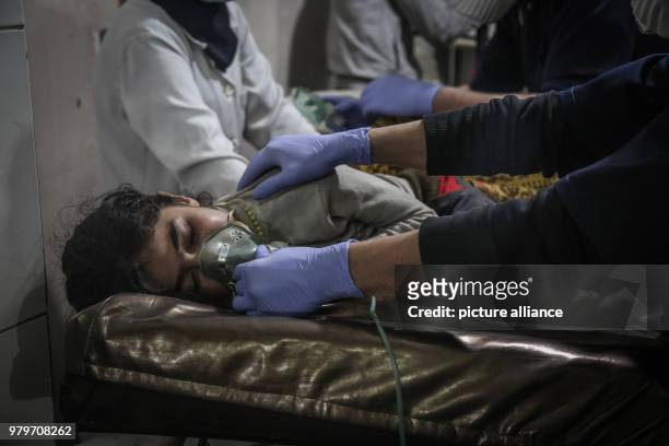 Dpatop - A Syrian child receives first aid after what local sources say was an attack by forces loyal to Syrian President Assad with chlorine gas on...