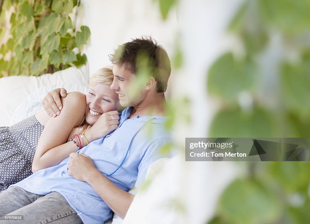 Couple hugging and laying on porch