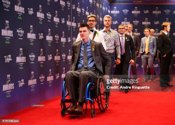 Jacob Wasserman leads his Humboldt Broncos teammates onto the red carpet as they arrive at the 2018 NHL Awards presented by Hulu at the Hard Rock...