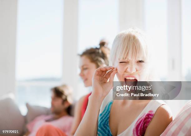 woman making face and holding hair above lip - mischief woman stock pictures, royalty-free photos & images