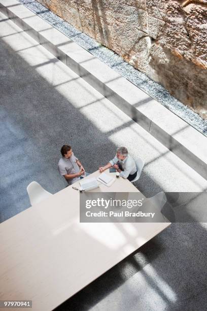 businessmen meeting at conference table - sydney from above stock pictures, royalty-free photos & images