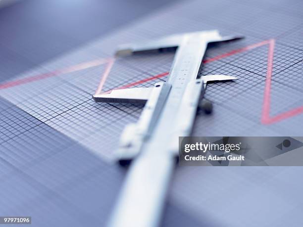 close up of vernier caliper on graph - calibrador fotografías e imágenes de stock