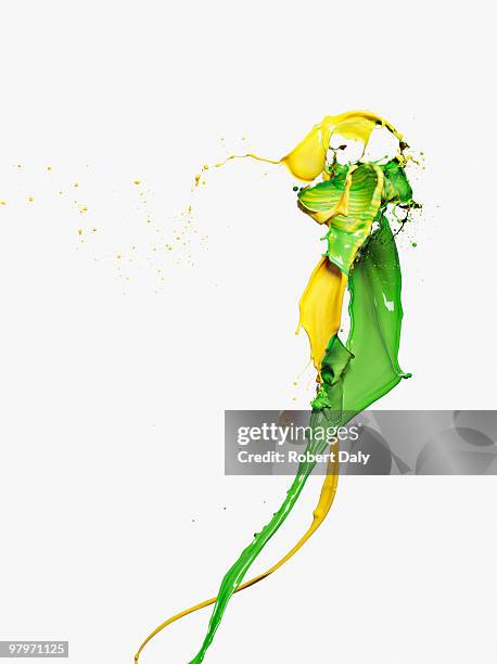 yellow and green paint colliding - colours merging stock pictures, royalty-free photos & images