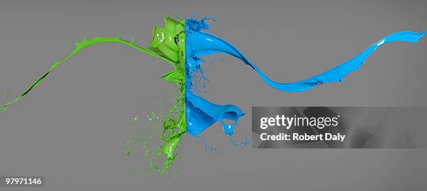 green and blue paint colliding - fusion stock pictures, royalty-free photos & images