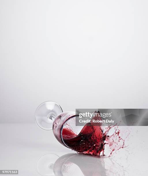 red wine spilling from glass - wine splash stock pictures, royalty-free photos & images