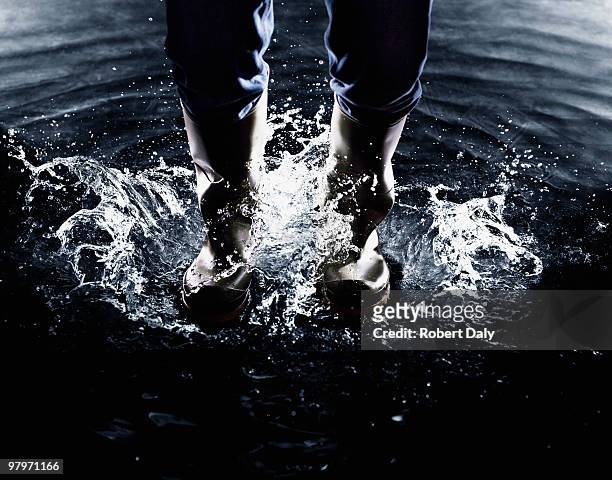 wellingtons splashing in water - robert madden stock pictures, royalty-free photos & images