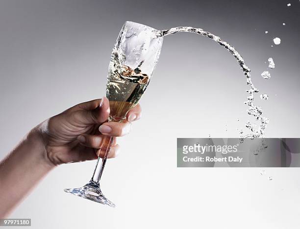 champagne spilling from glass - robert a daly bildbanksfoton och bilder