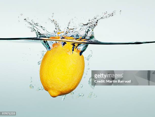 lemon splashing in water - sunken stock pictures, royalty-free photos & images