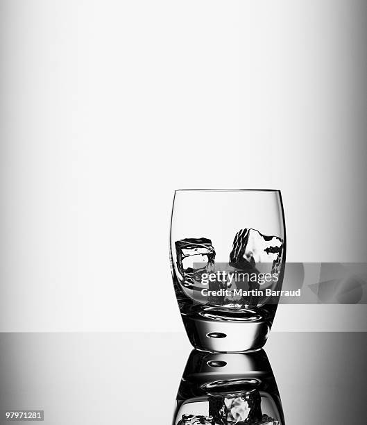 ice cubes in highball glass - highball glass stock pictures, royalty-free photos & images