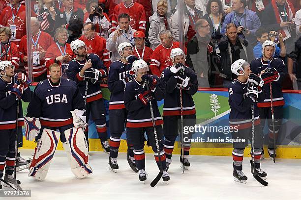 Bobby Ryan, goaltender Tim Thomas, Chris Drury, David Backes, Dustin Brown, Paul Stastny, Joe Pavelski and Ryan Callahan of USA look on dejectedly...