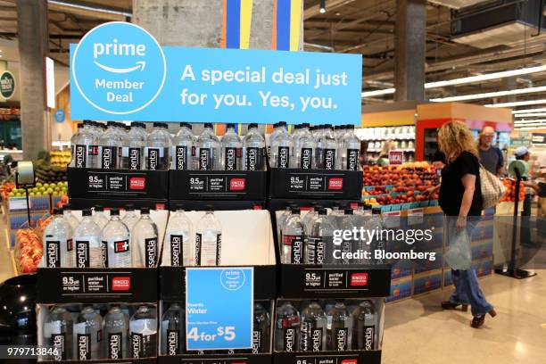 Sign alerts Amazon.com Inc. Prime members of a special deal on bottled water during the grand opening of a Whole Foods Market Inc. Location in...