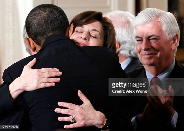 President Barack Obama hugs widow of the late Sen. Edward Kennedy Vicki Kennedy as Sen. Chirstopher Dodd looks on after he signed the Affordable...